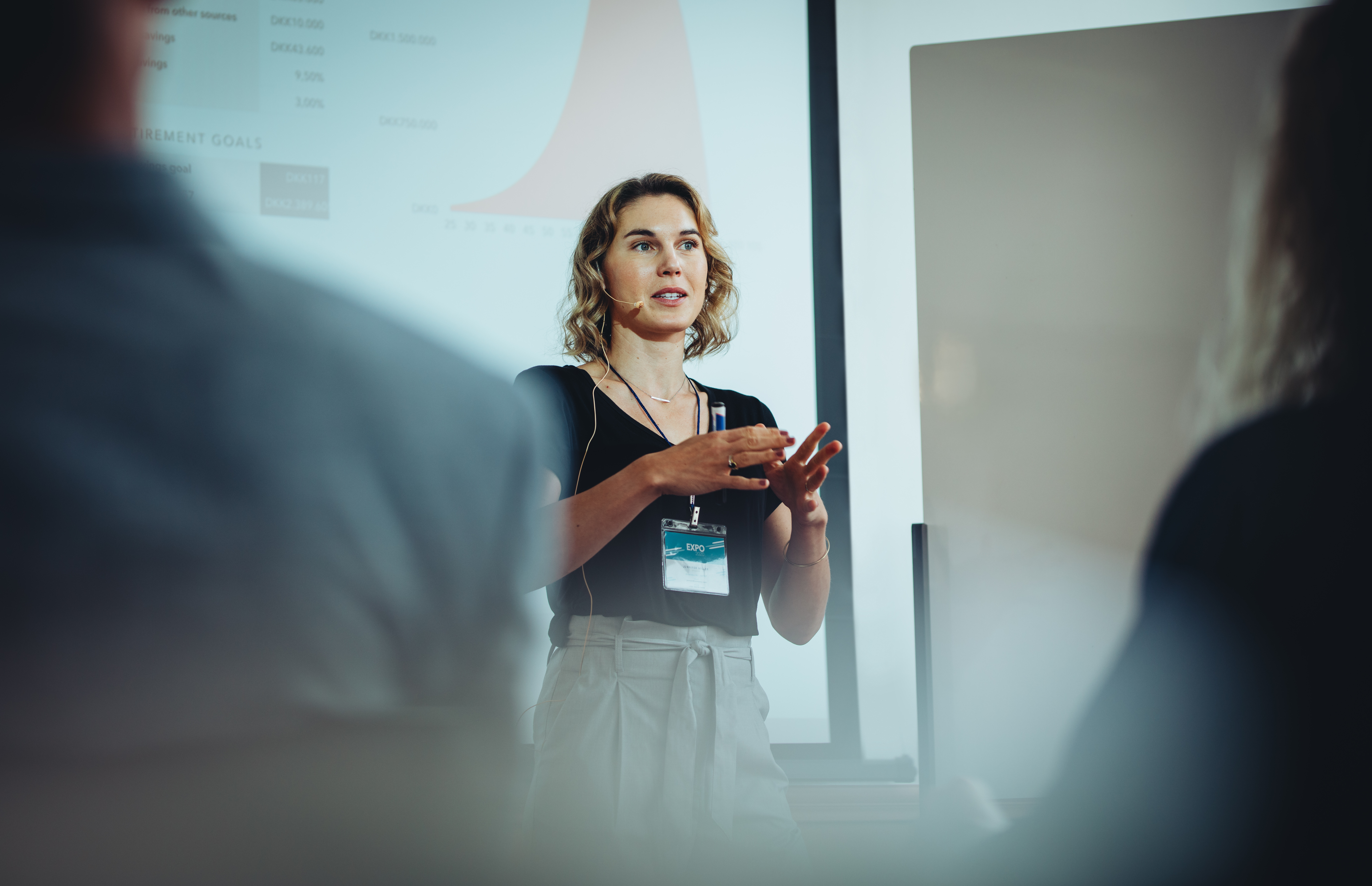 A business owner discussing ideas in front of a projector screen